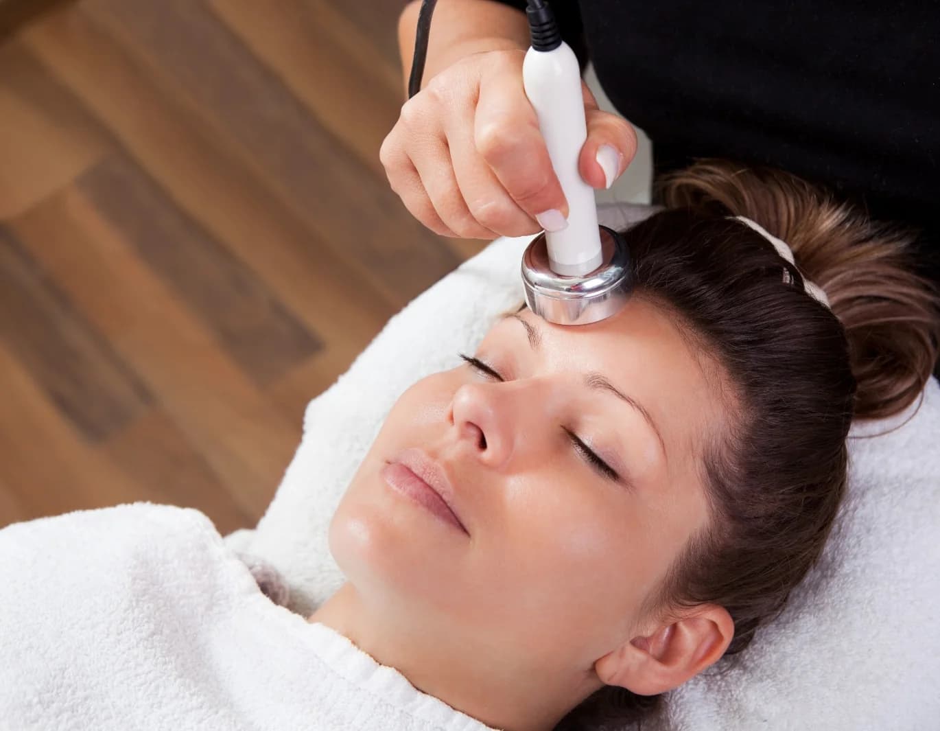 A client relaxing during a facial treatment at Skin Med Spa