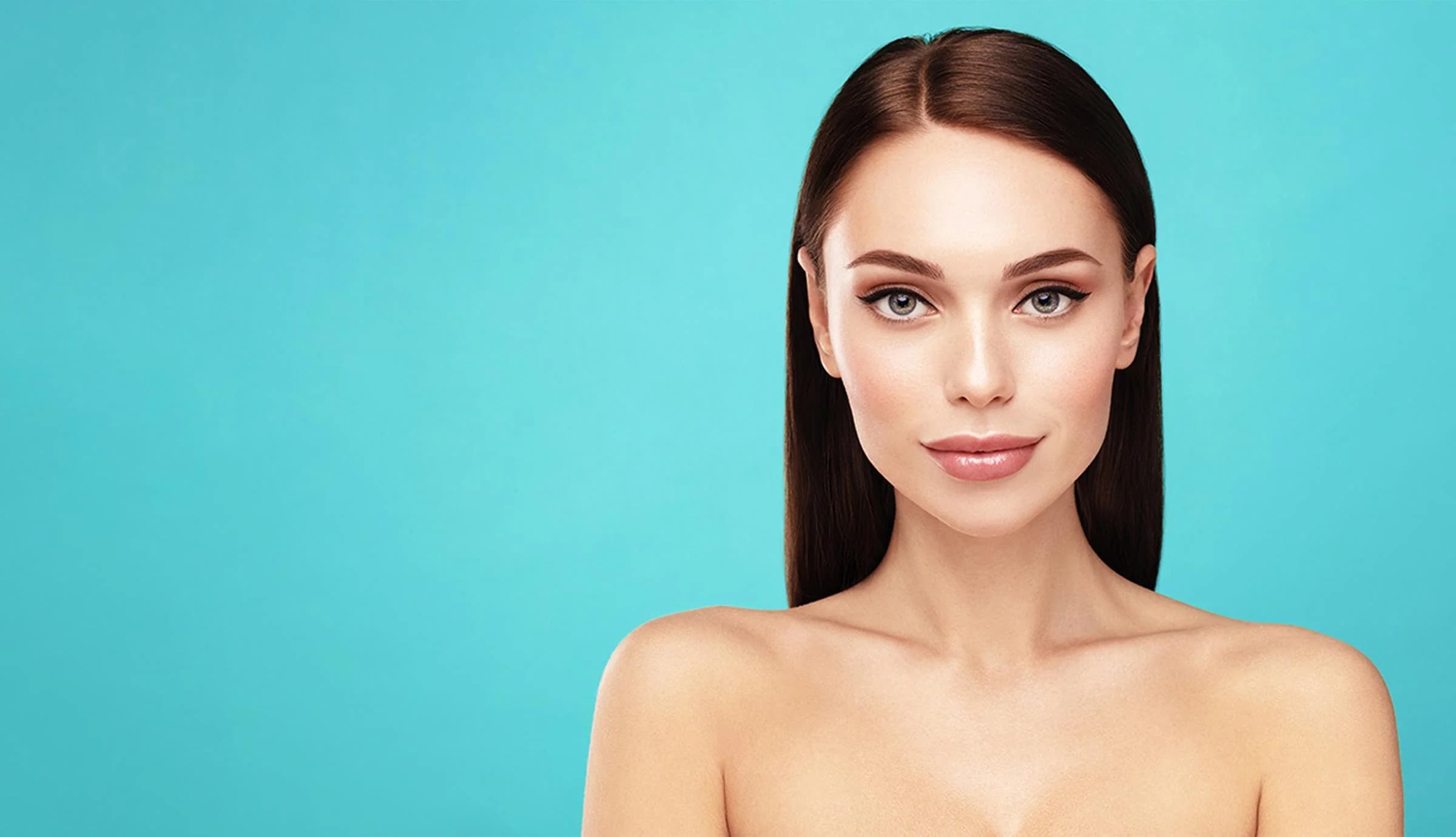 Woman with smooth, radiant skin and natural makeup against a teal backdrop