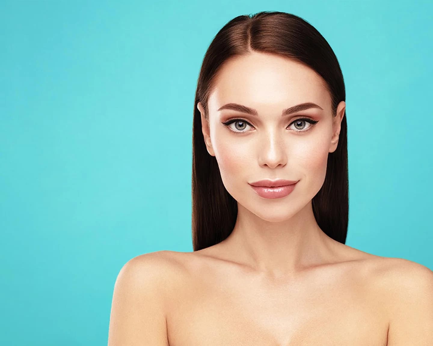 Woman with smooth, luminous skin against a teal backdrop